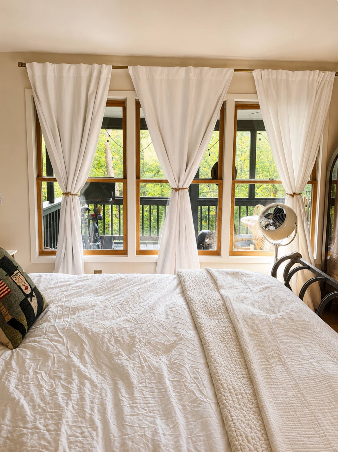 Bedroom facing a wooded deck
